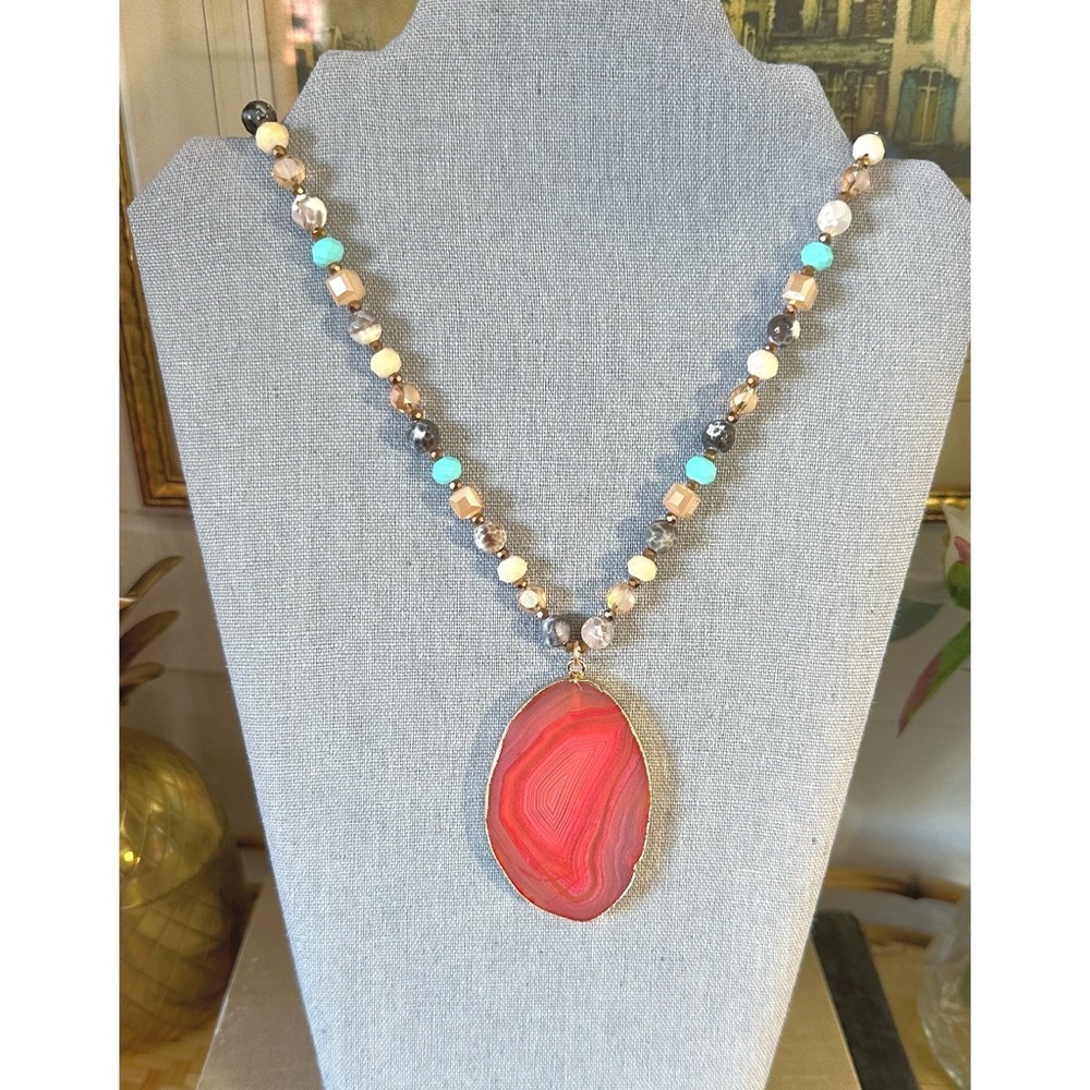 Beaded necklace featuring a large, gold-trimmed pink & red agate slice pendant